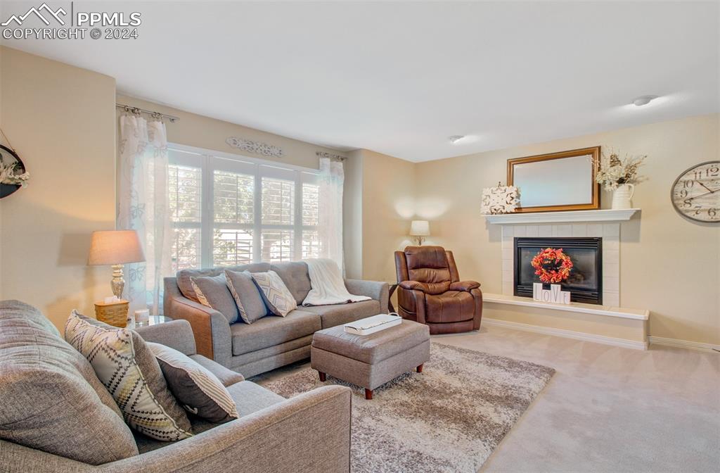 12110 Lazy E Road Peyton, CO 80831 - Photo 7 of 50 a living room with furniture and a fireplace