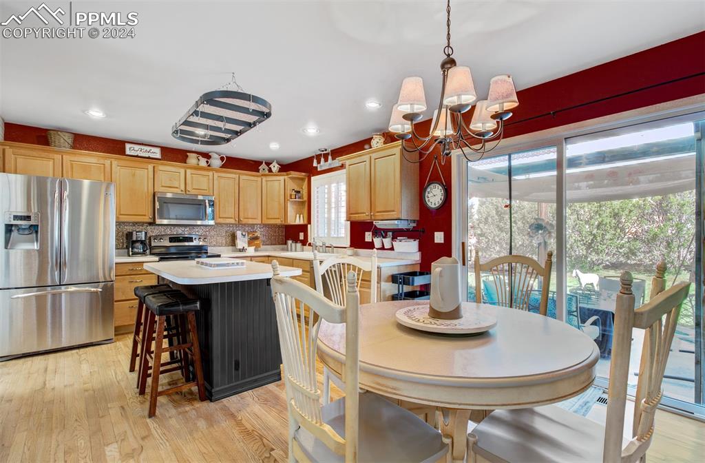 12110 Lazy E Road Peyton, CO 80831 - Photo 8 of 50 a kitchen with stainless steel appliances granite countertop a sink a stove and a refrigerator