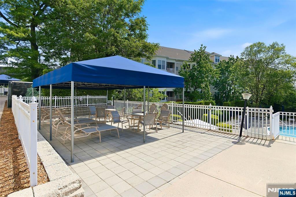 280 Prospect Avenue, Unit 8G Hackensack, NJ 07601 - Photo 21 of 23 a view of a patio with a table and chairs