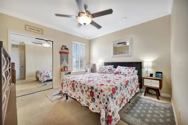 a bedroom with a bed and dresser with mirror