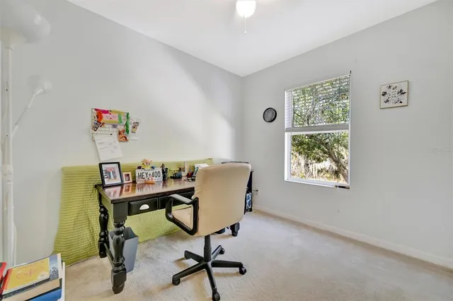 a view of a workspace with furniture and a window