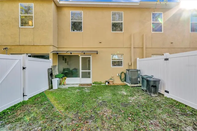 a front view of a house with porch and furniture