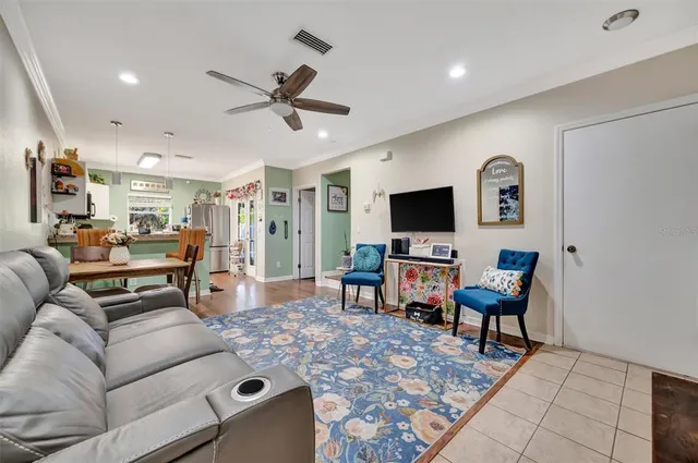 a kitchen with granite countertop a refrigerator and microwave