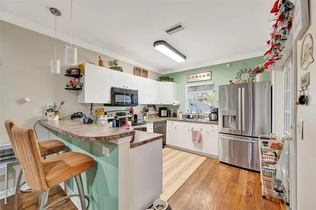 a kitchen with granite countertop stainless steel appliances and wooden cabinets