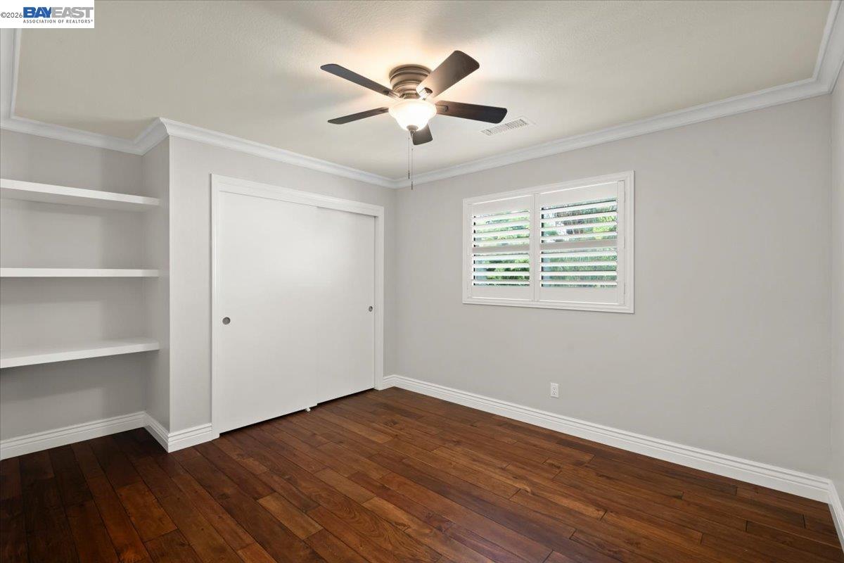 1784 Creek Road Livermore, CA 94550 - Photo 27 of 40 a view of an empty room with wooden floor and a ceiling fan