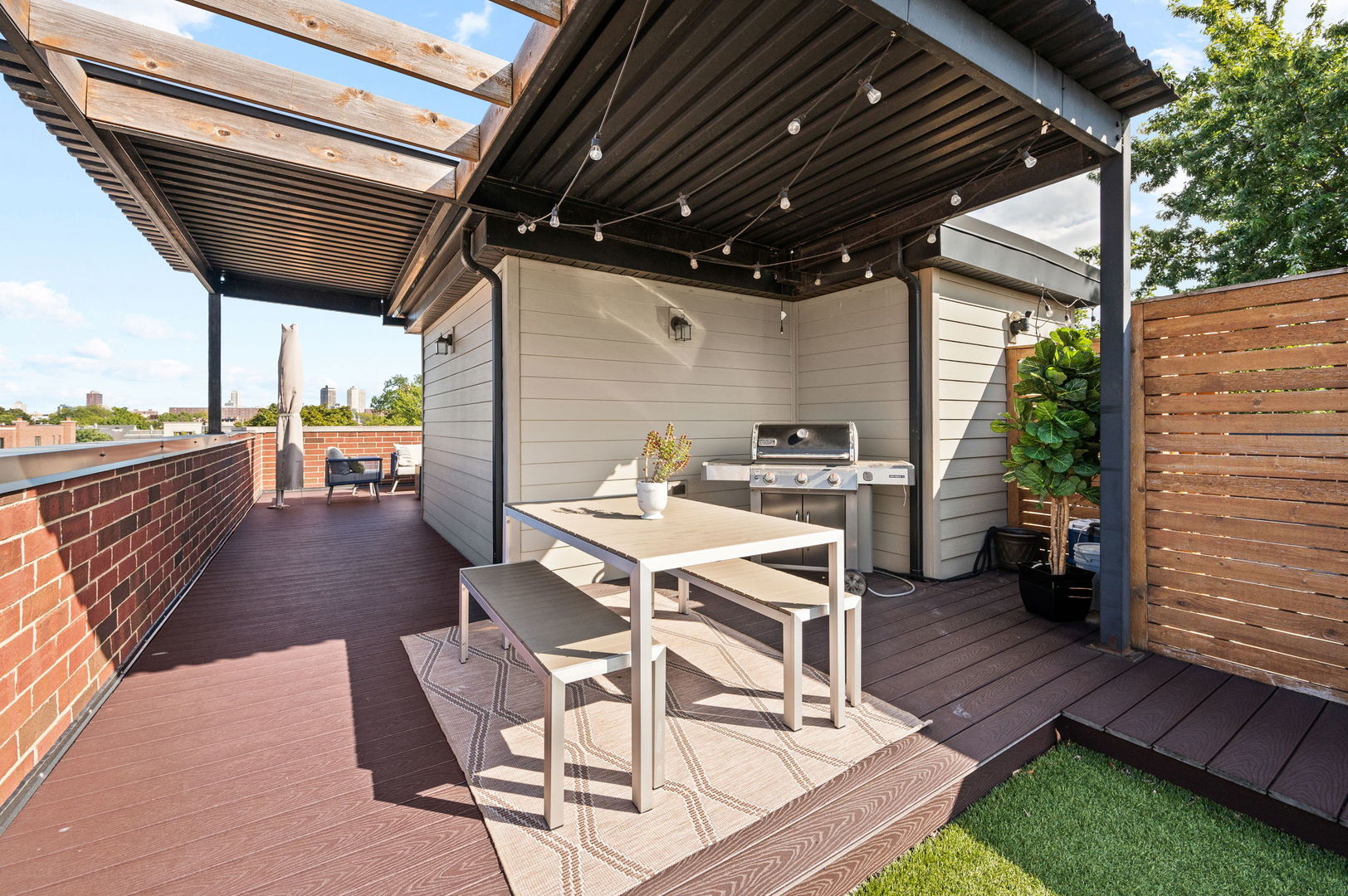 2700 North Wayne Avenue, Unit 3N Chicago, IL 60614 - Photo 20 of 22 a view of a patio with table and chairs a barbeque with wooden floor and roof with floor to ceiling window and wooden floor