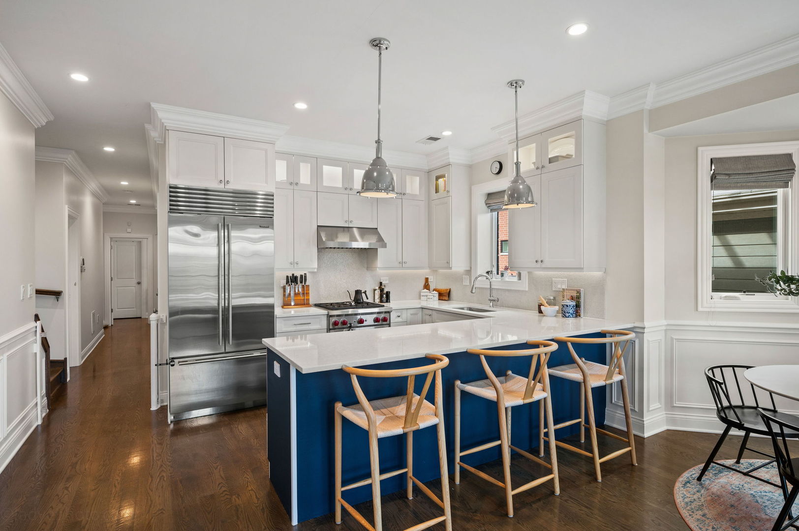2700 North Wayne Avenue, Unit 3N Chicago, IL 60614 - Photo 7 of 22 a kitchen with stainless steel appliances a dining table chairs and sink
