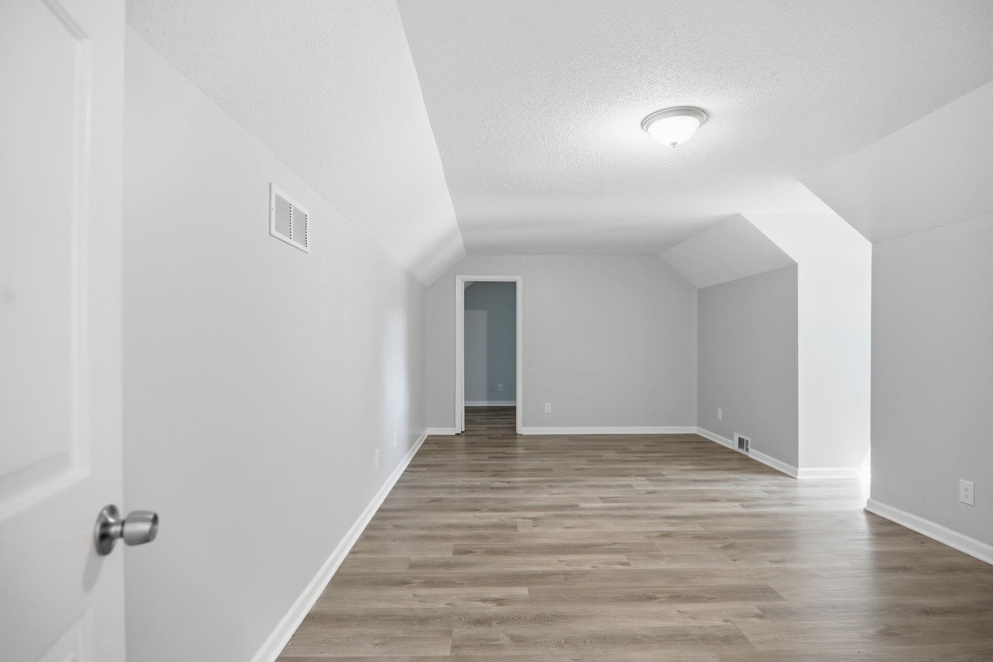 3113 Raleigh Ridge Cove Memphis, TN 38128 - Photo 26 of 38 Spacious room featuring wood-finish flooring, light gray walls, and white trim