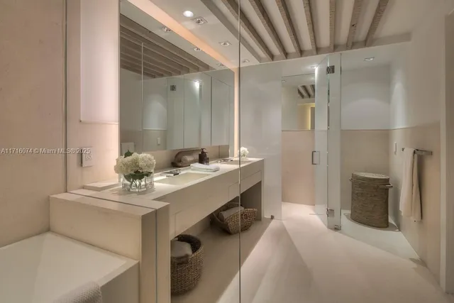 a en suite bathroom with a sink double vanity and a mirror