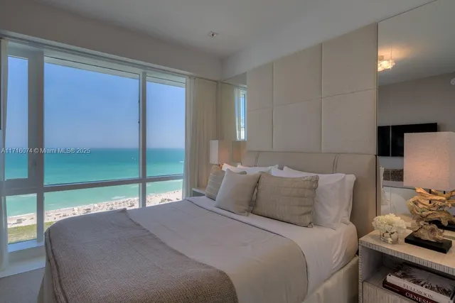 a bedroom with a bed and large window