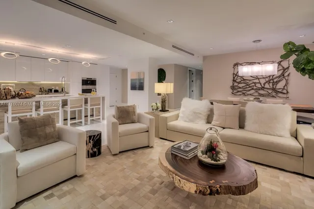 a living room with furniture kitchen and a table