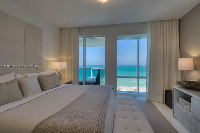 a bedroom with a bed and a lamp