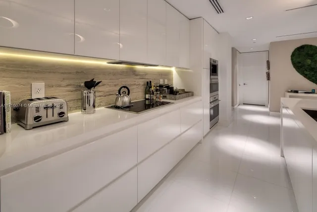 a kitchen with furniture and a flat screen tv