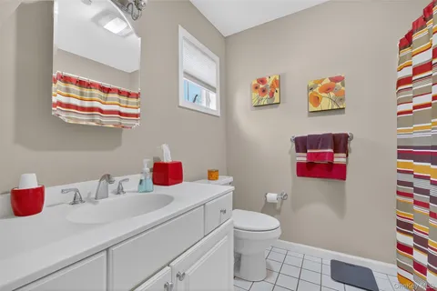 a bathroom with a sink vanity mirror and toilet