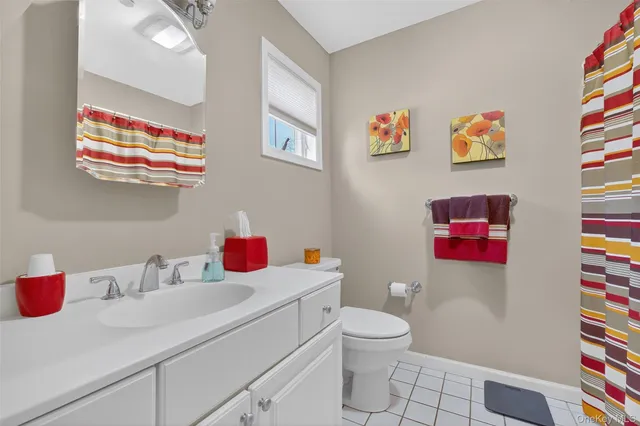 a bathroom with a sink vanity mirror and toilet