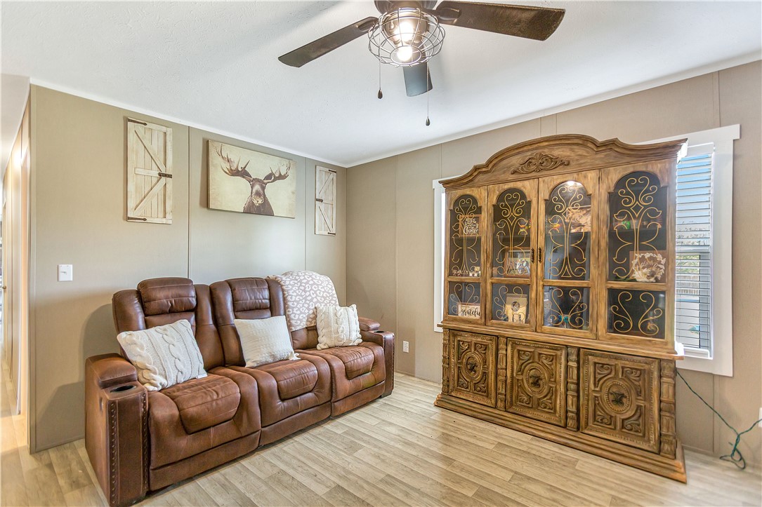 633 Project Road Iva, SC 29655 - Photo 13 of 38 This living area features a ceiling fan, durable flooring, and ample natural light, and fireplace.
