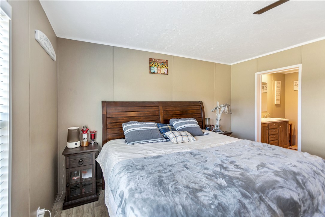 633 Project Road Iva, SC 29655 - Photo 18 of 38 This cozy bedroom offers a tranquil retreat with convenient access to a private bathroom.