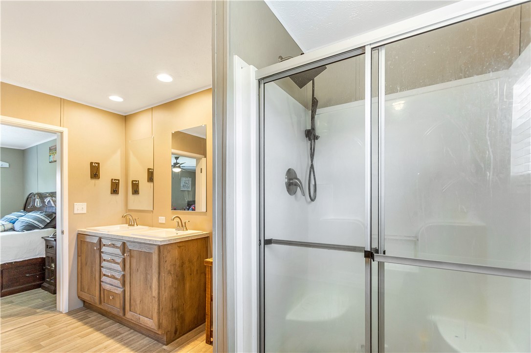 633 Project Road Iva, SC 29655 - Photo 20 of 38 This primary bathroom features a dual vanity and a spacious stand-up shower.