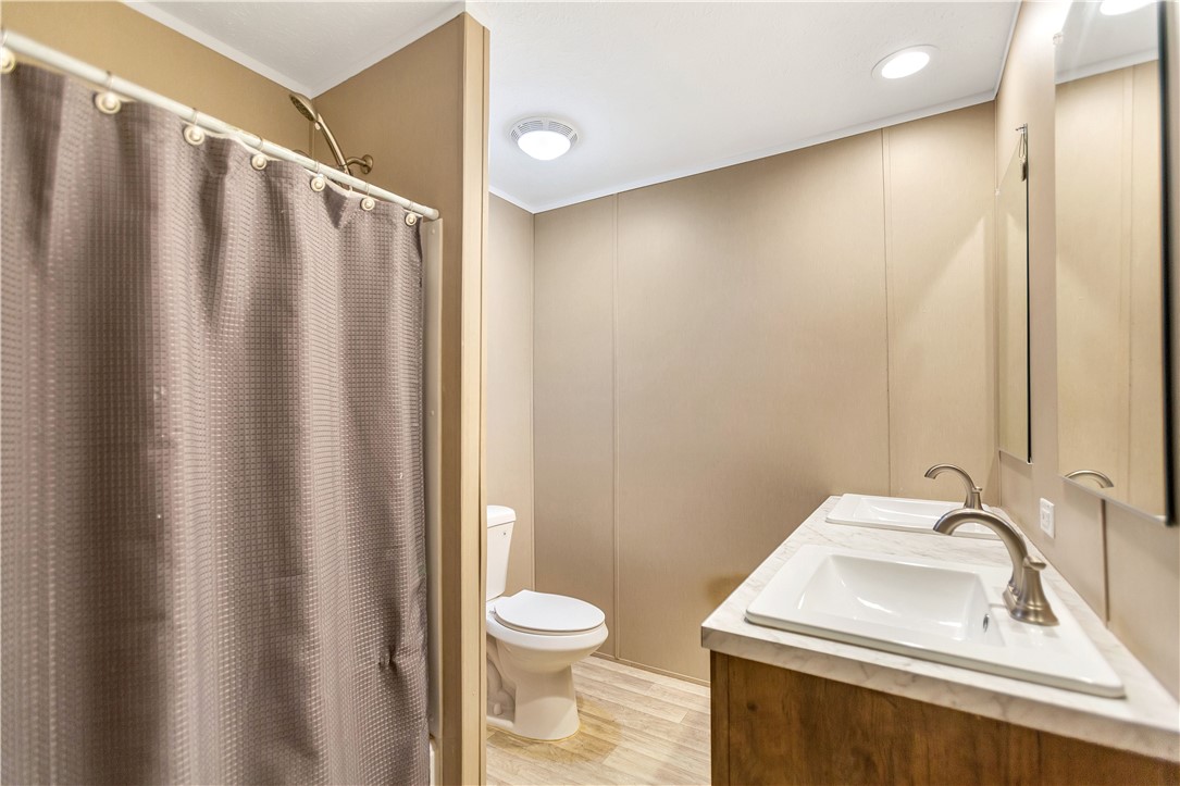 633 Project Road Iva, SC 29655 - Photo 25 of 38 This bathroom features dual sinks, a shower, and modern fixtures, all designed for comfort and ease.