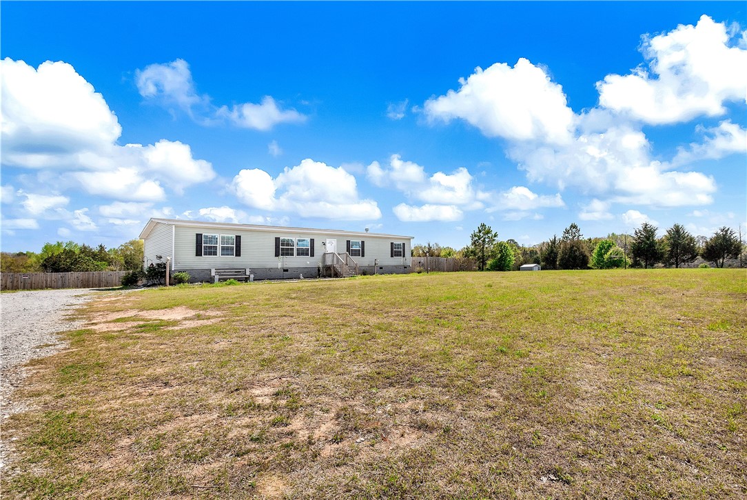 633 Project Road Iva, SC 29655 - Photo 27 of 38 This expansive property features a charming home nestled in a spacious, verdant landscape.