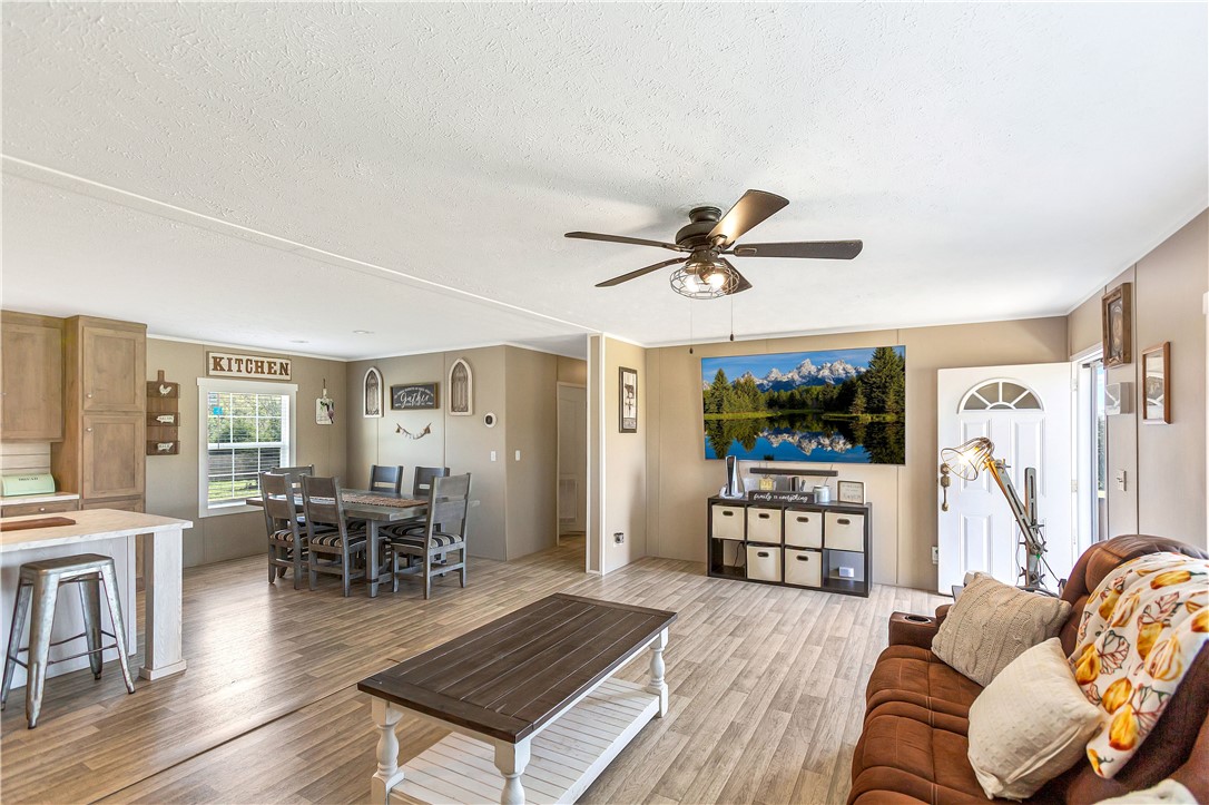 633 Project Road Iva, SC 29655 - Photo 4 of 38 This inviting space combines a cozy living area with an open-plan kitchen and dining zone.