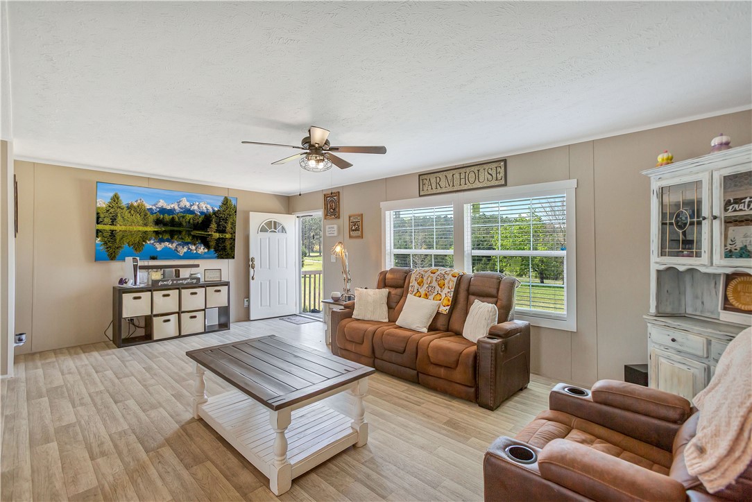633 Project Road Iva, SC 29655 - Photo 5 of 38 This inviting living room features durable flooring and ample natural light through large windows.