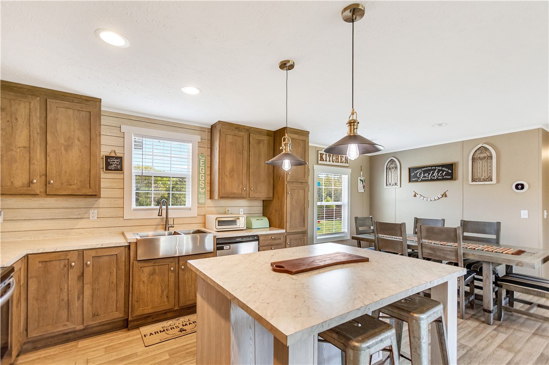 633 Project Road Iva, SC 29655 - Photo 9 of 38 This kitchen and dining area provides a perfect gathering space for culinary adventures and shared meals.