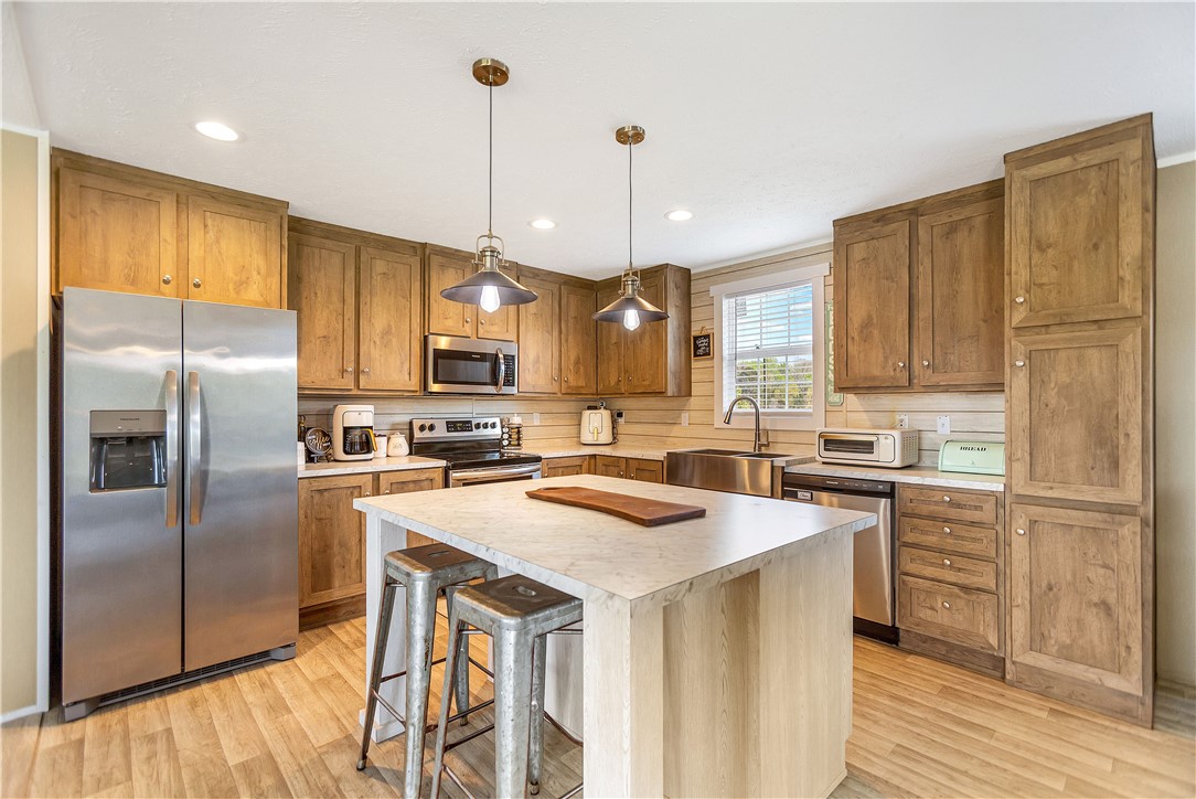 633 Project Road Iva, SC 29655 - Photo 10 of 38 This bright kitchen features wood cabinetry and a functional island, perfect for casual meals.
