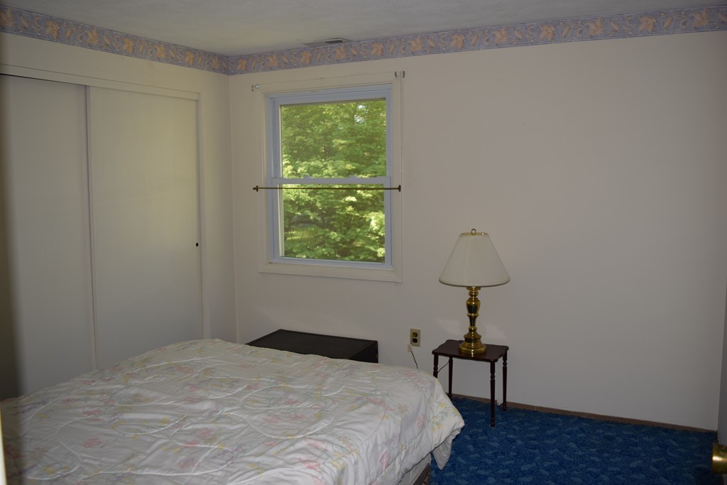 71 Old Stage Road Chelmsford, MA 01824 - Photo 11 of 15 a bedroom with a bed and a window