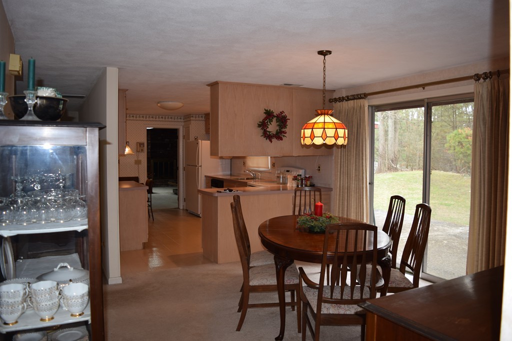 71 Old Stage Road Chelmsford, MA 01824 - Photo 4 of 15 a view of a dining room with furniture window and outside view