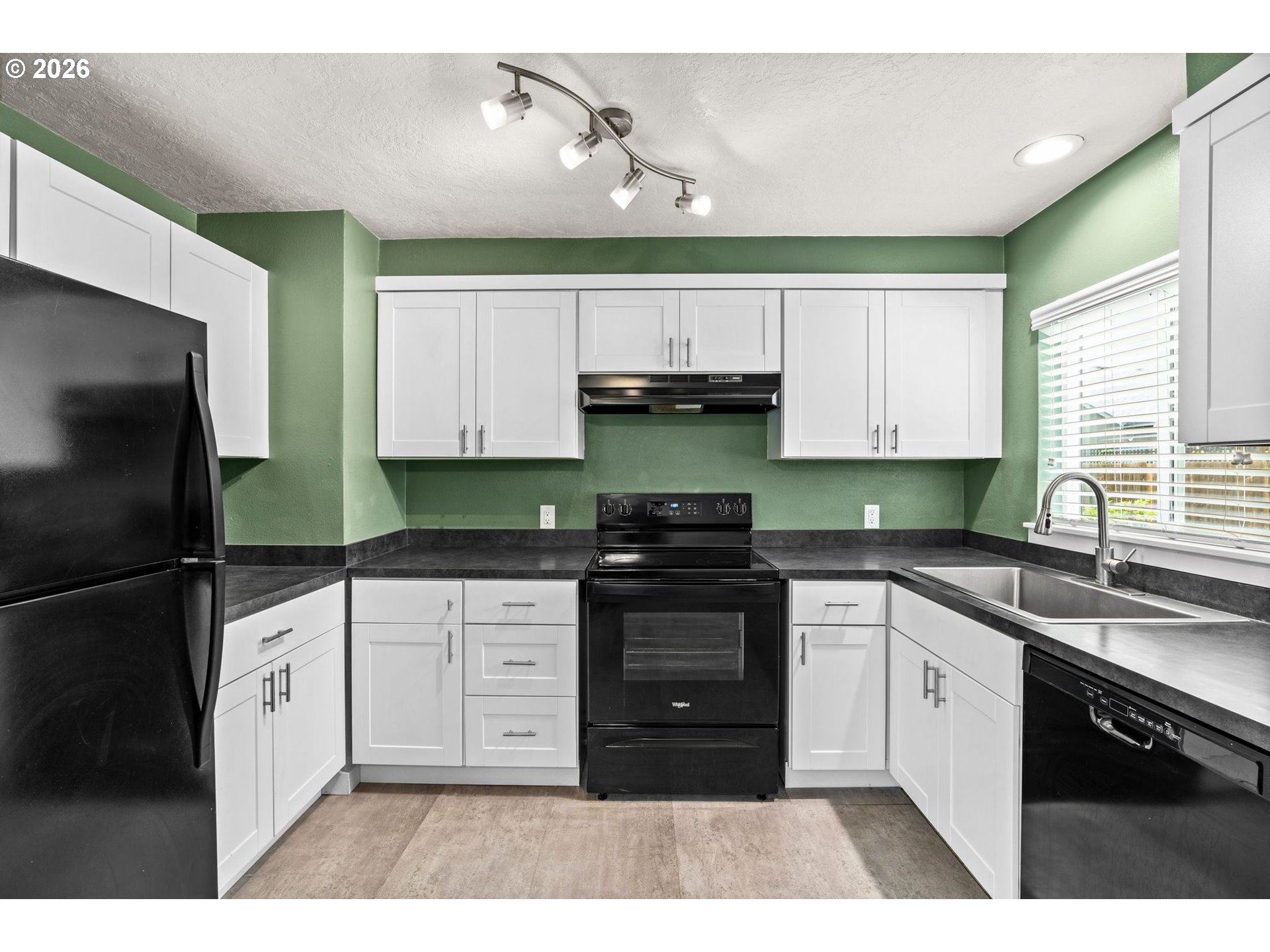 3155 Bell Avenue Eugene, OR 97402 - Photo 11 of 30 a kitchen with stainless steel appliances granite countertop a sink a stove a refrigerator and cabinets