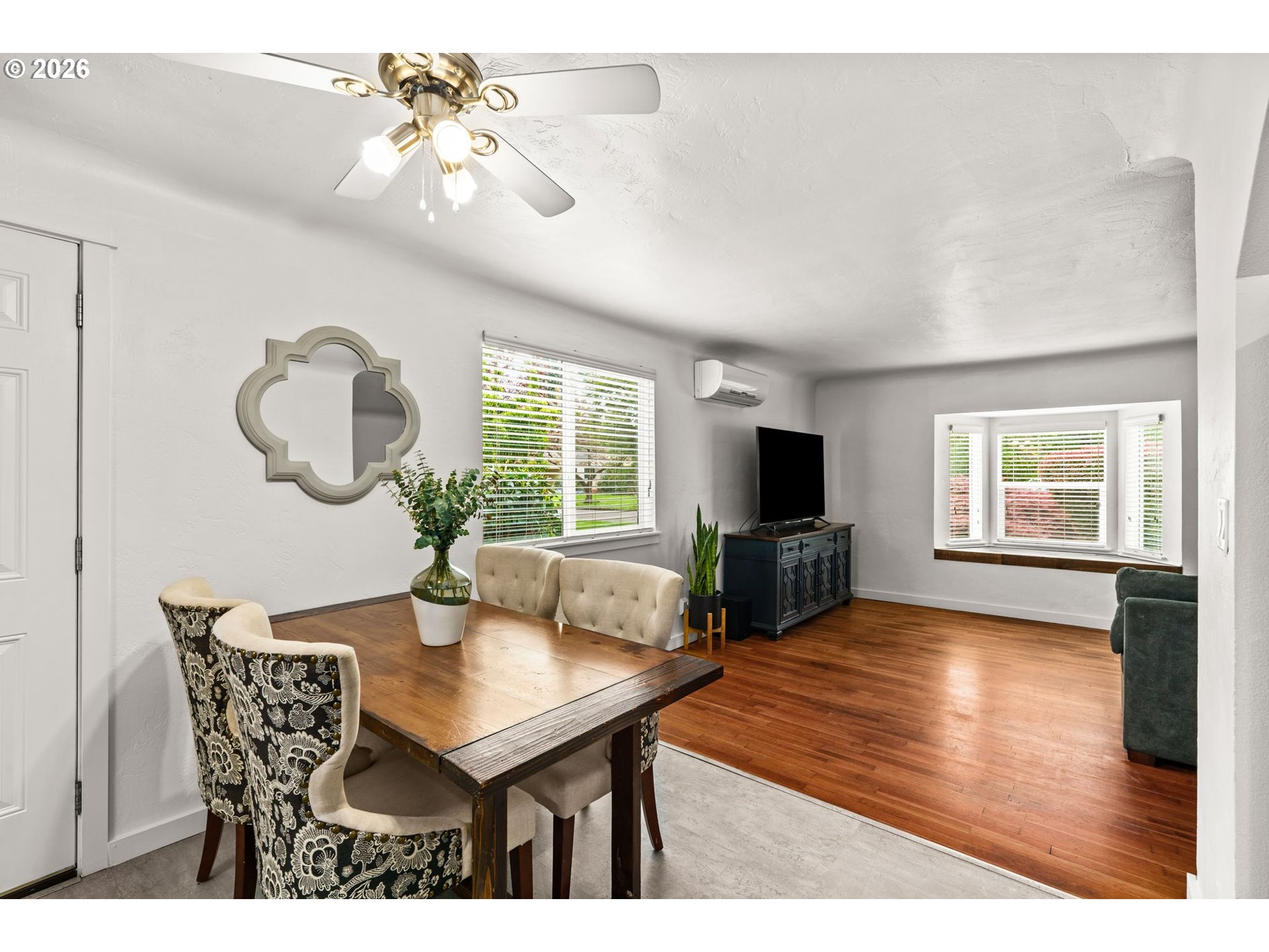 3155 Bell Avenue Eugene, OR 97402 - Photo 14 of 30 a view of a dining room with furniture a fireplace and wooden floor
