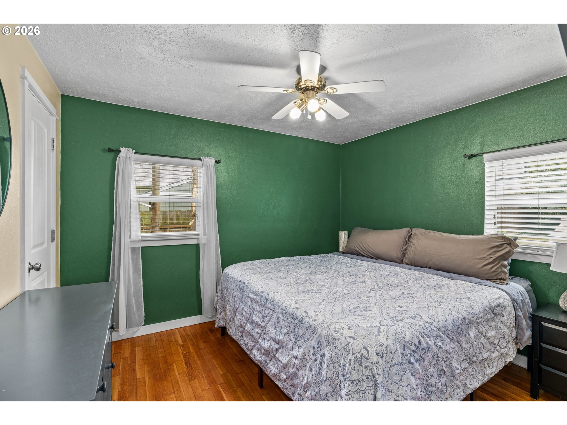 3155 Bell Avenue Eugene, OR 97402 - Photo 19 of 30 a bedroom with a large bed and a chandelier