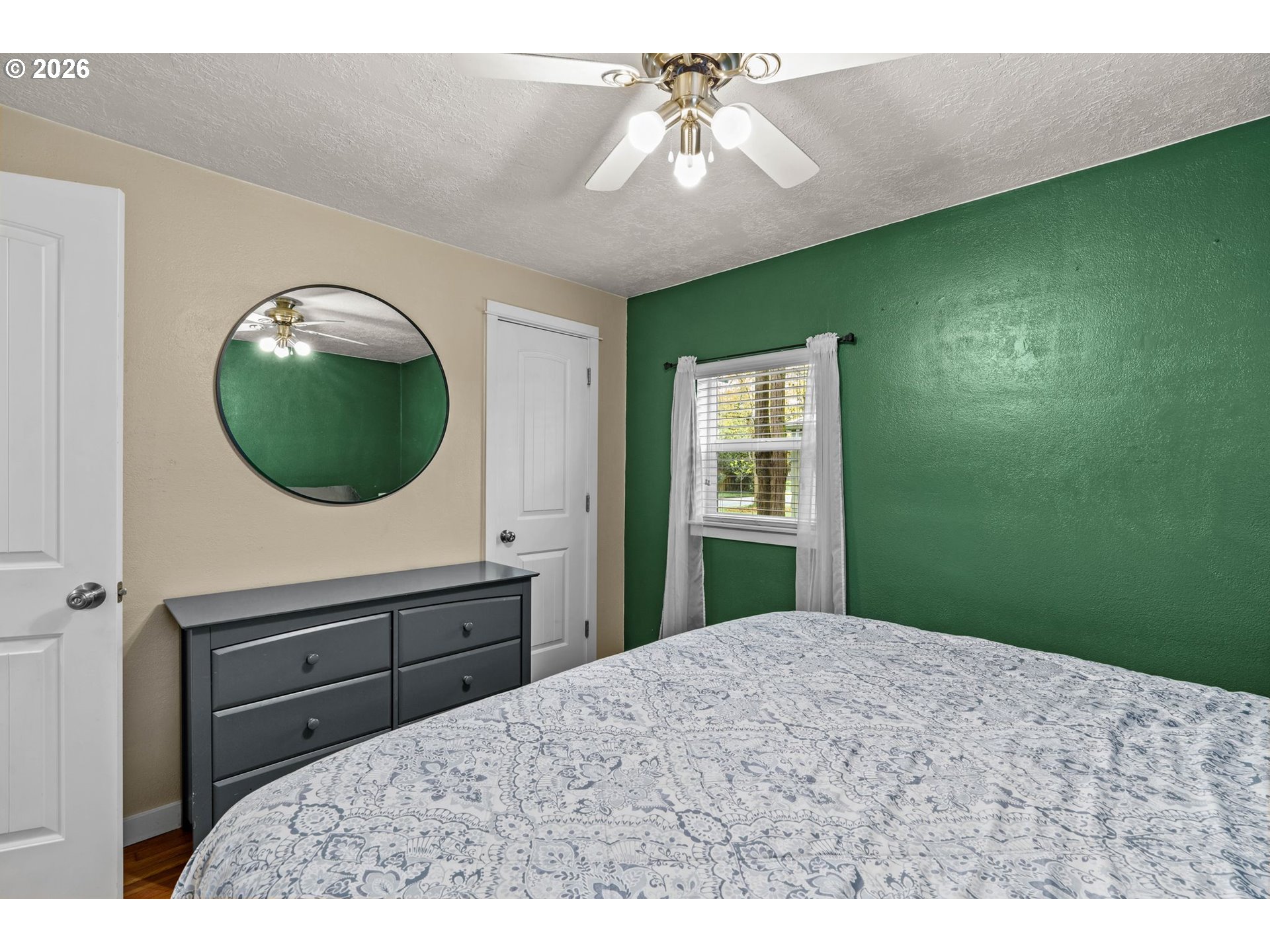 3155 Bell Avenue Eugene, OR 97402 - Photo 21 of 30 a bedroom with a bed and a chandelier