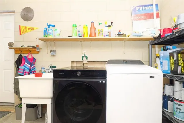 a utility room with dryer washer and a fridge