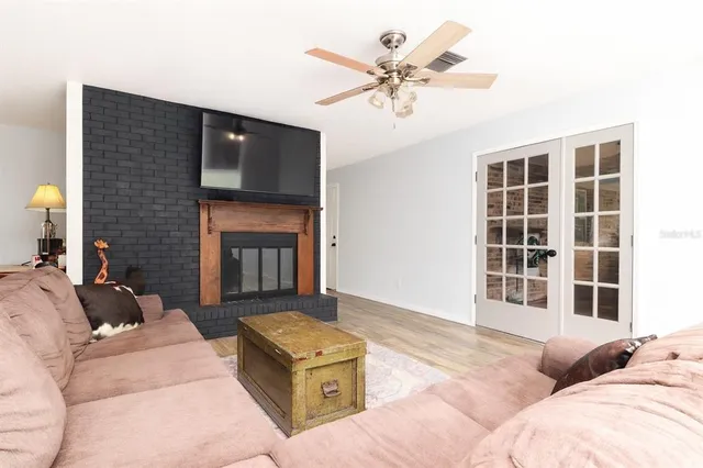 a living room with furniture a fireplace and a flat screen tv
