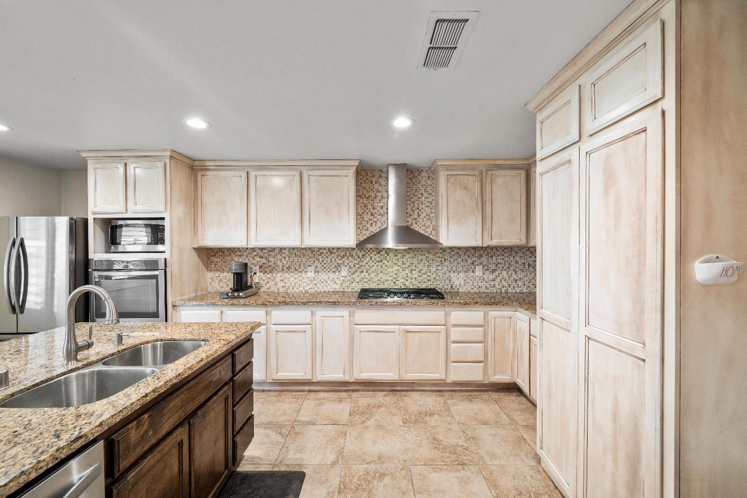 2768 Butte House Road Yuba City, CA 95993 - Photo 14 of 43 a kitchen with stainless steel appliances granite countertop a sink stove and refrigerator