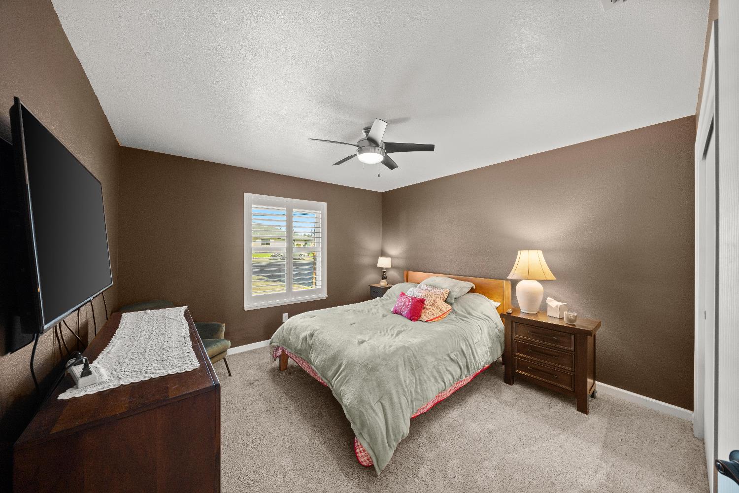 2768 Butte House Road Yuba City, CA 95993 - Photo 21 of 43 a bedroom with a bed and a chandelier