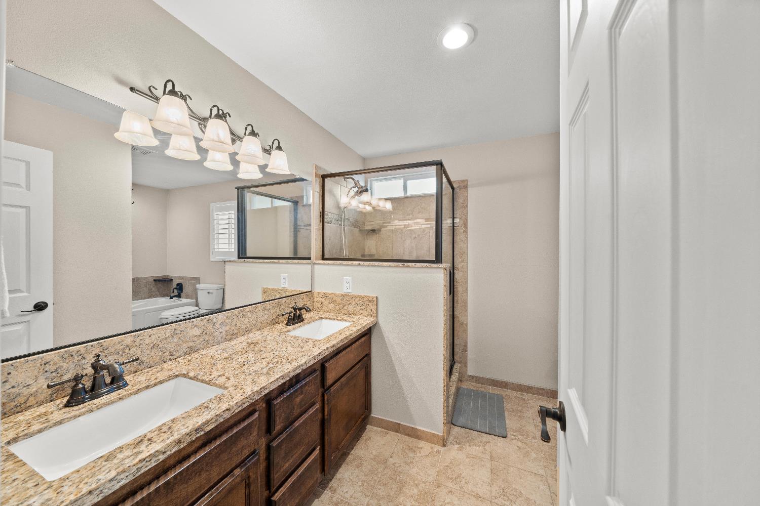 2768 Butte House Road Yuba City, CA 95993 - Photo 26 of 43 a bathroom with a granite countertop sink and a mirror