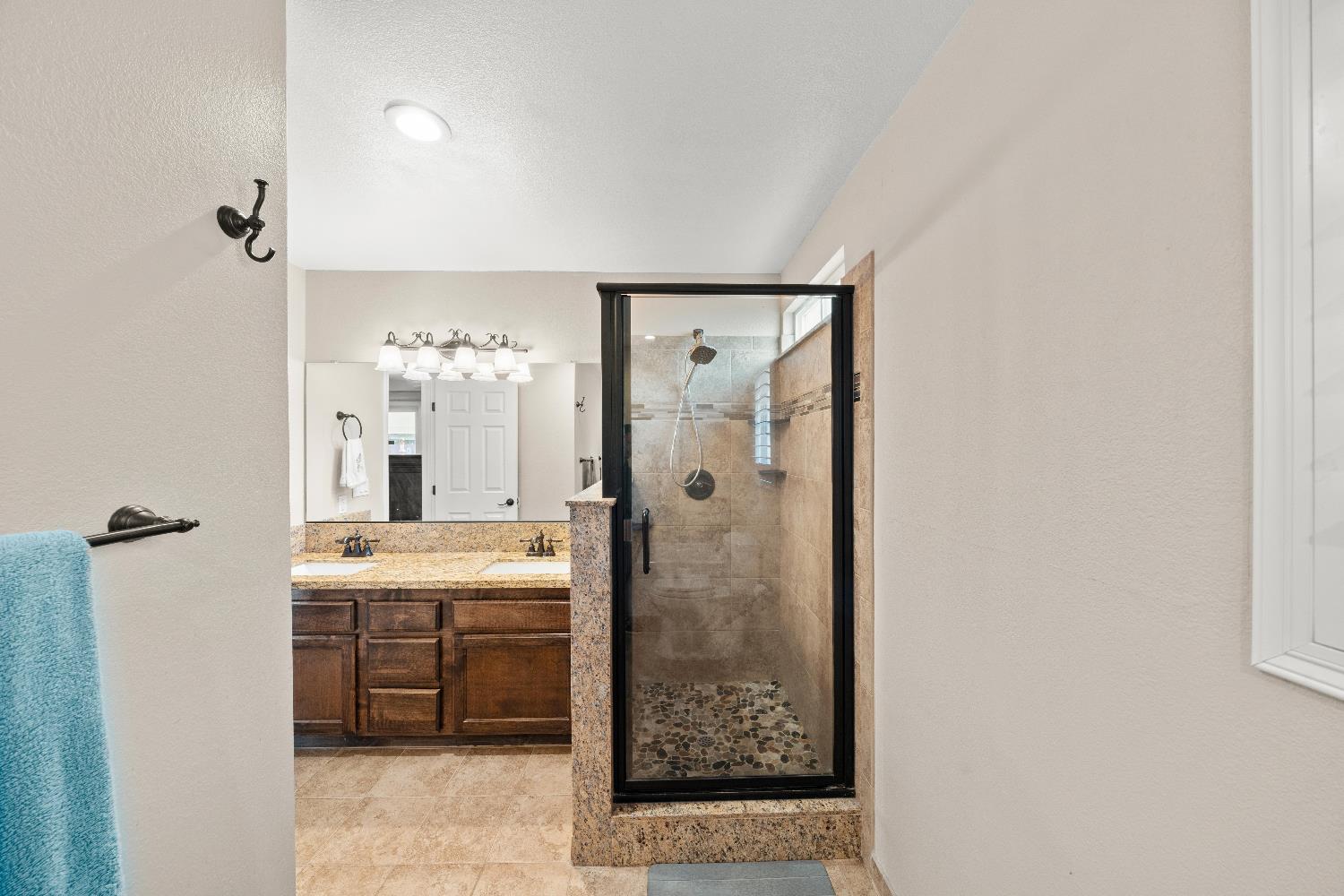 2768 Butte House Road Yuba City, CA 95993 - Photo 27 of 43 a bathroom with a granite countertop shower a mirror and a sink