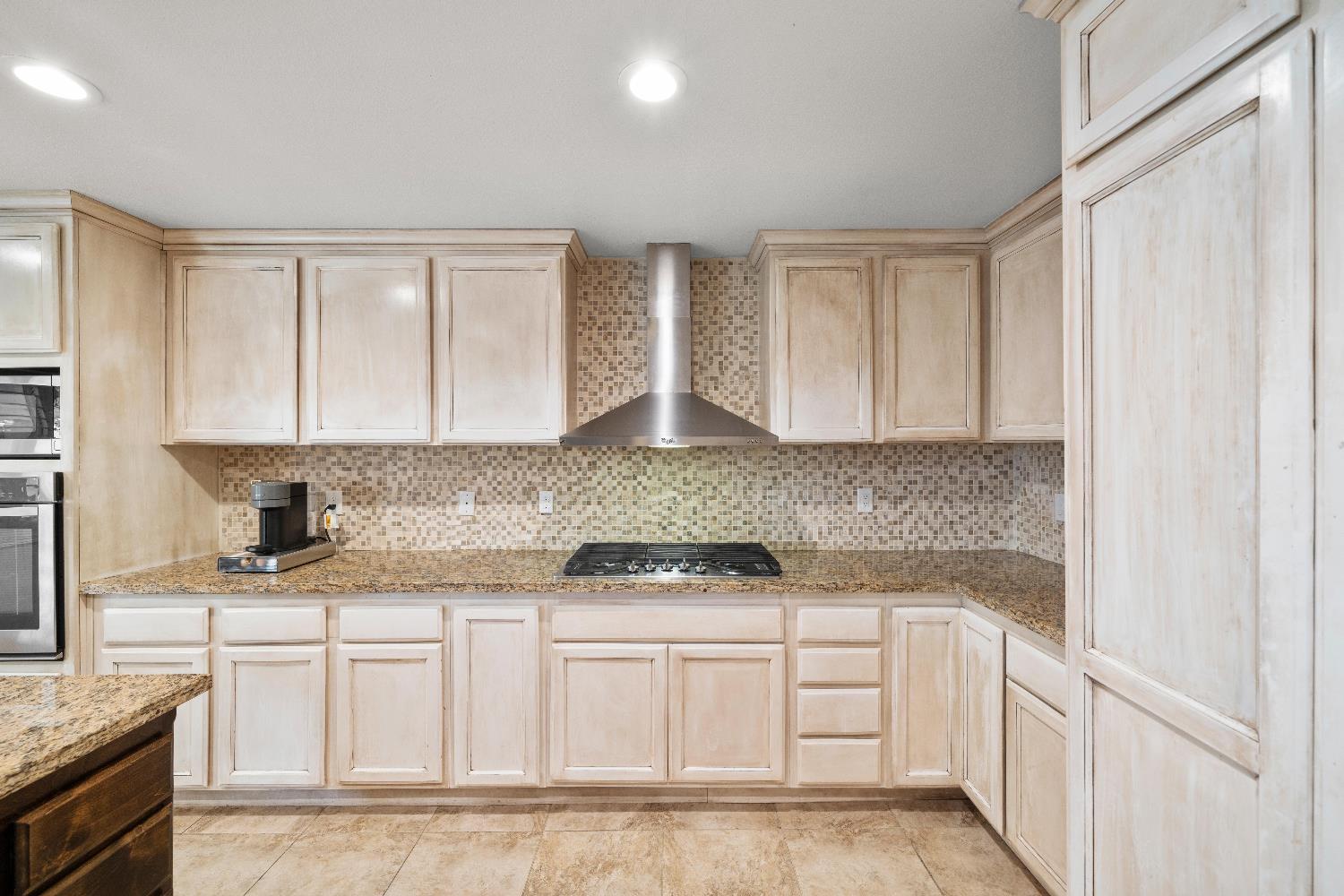 2768 Butte House Road Yuba City, CA 95993 - Photo 4 of 43 a kitchen with granite countertop white cabinets and white appliances