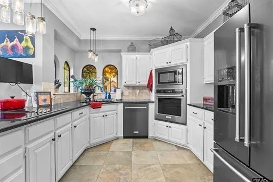 a kitchen with stainless steel appliances a refrigerator sink and microwave