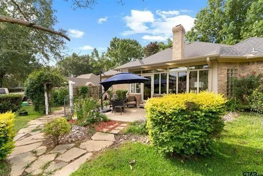 a backyard of a house with yard barbeque oven and outdoor seating