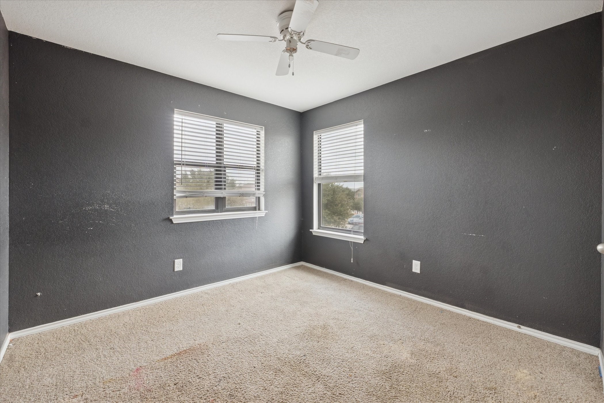 6630 San Miguel Way Converse, TX 78109 - Photo 12 of 14 en empty room with windows and ceiling fan