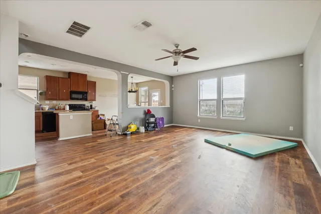 a view of a livingroom with a computer on the desk and chair