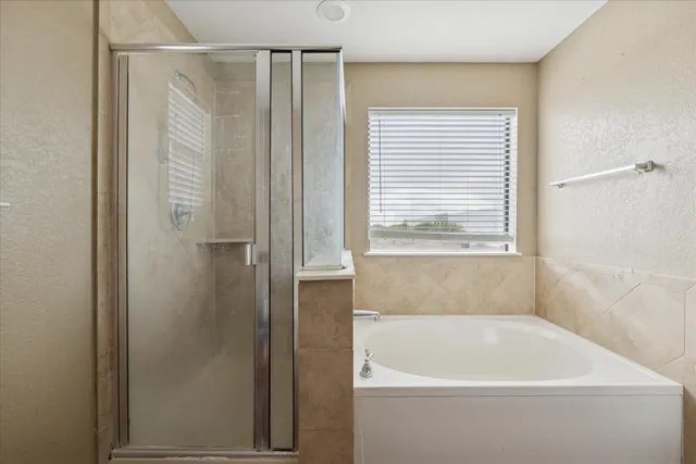 a white bath tub sitting next to a window