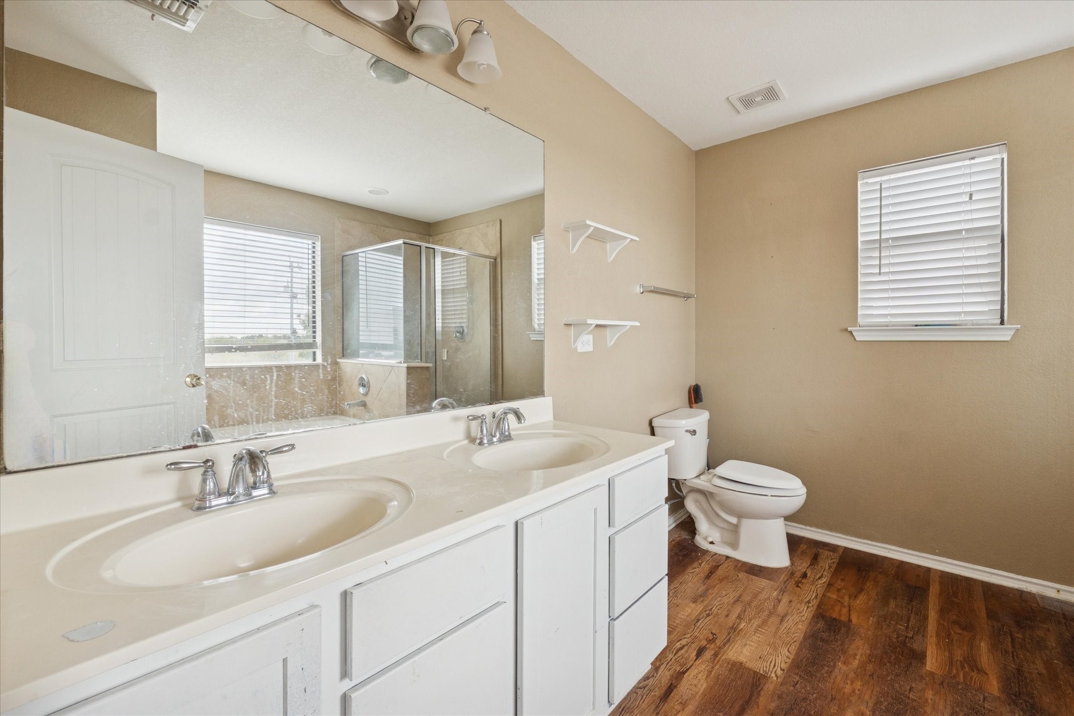 6630 San Miguel Way Converse, TX 78109 - Photo 10 of 14 a bathroom with a sink a toilet and a mirror