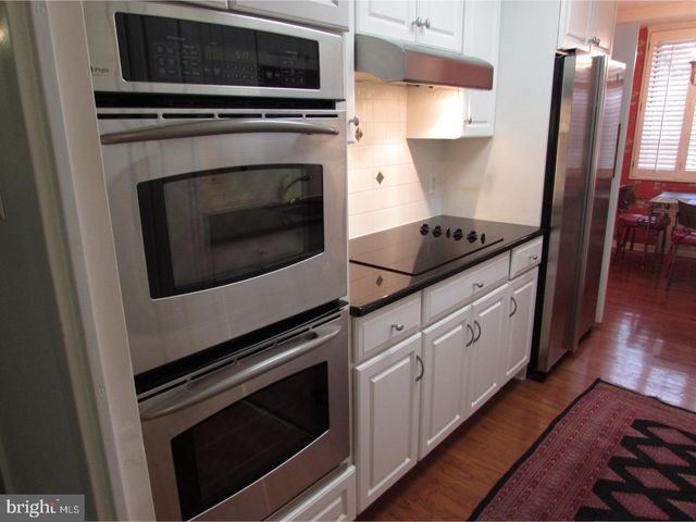 a kitchen with granite countertop a stove microwave and sink