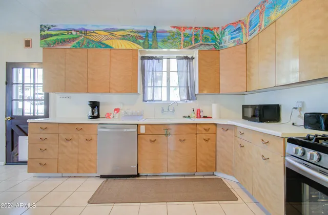 a kitchen with stainless steel appliances a sink and a refrigerator