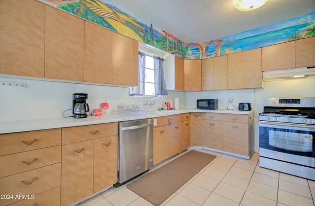 a kitchen with granite countertop white cabinets and sink